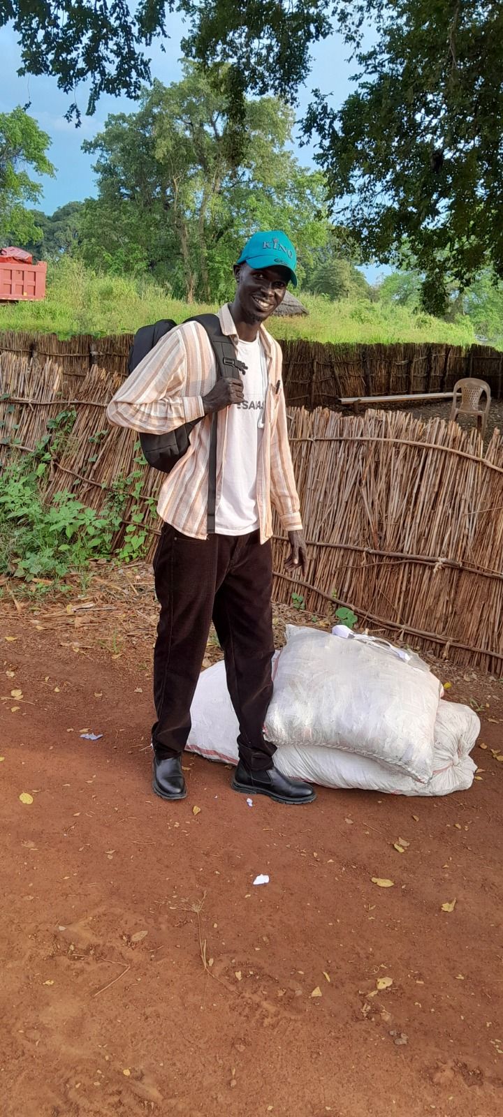 Buay from Pesabase standing next to sacks of RUTF before the journey to Maiwut